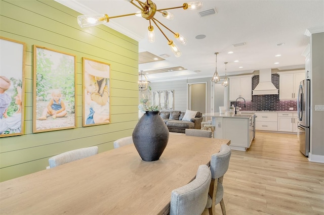 1919 Woodleaf Hammock Ct, Bradenton, FL 34211 - dining space featuring ornamental molding, light wood-type flooring, a chandelier, wood walls, and recessed lighting