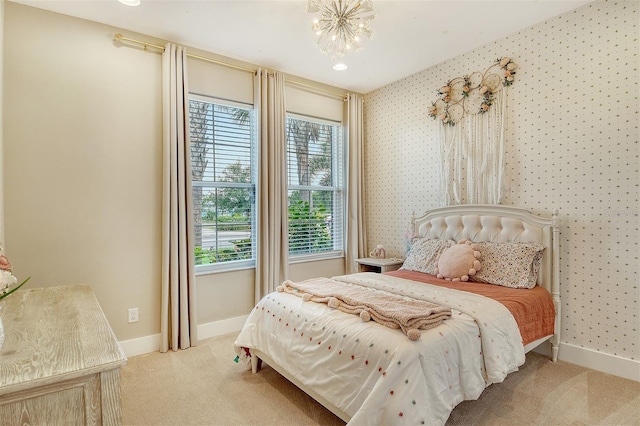1919 Woodleaf Hammock Ct, Bradenton, FL 34211 - bedroom with light carpet, multiple windows, baseboards, and a chandelier