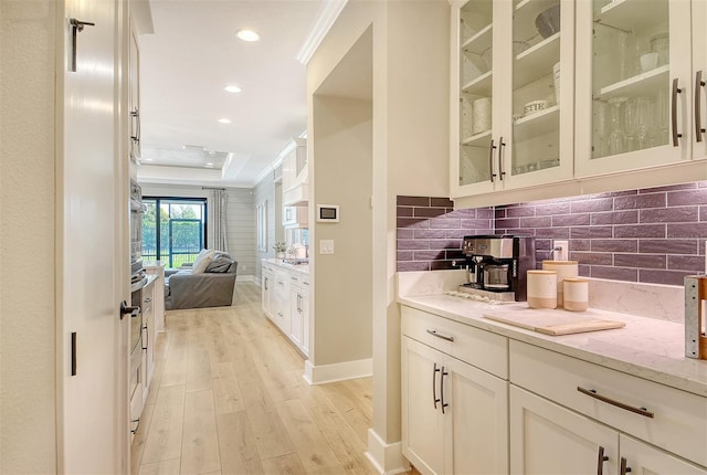 1919 Woodleaf Hammock Ct, Bradenton, FL 34211 - bar featuring light wood-style flooring, tasteful backsplash, crown molding, recessed lighting, and baseboards