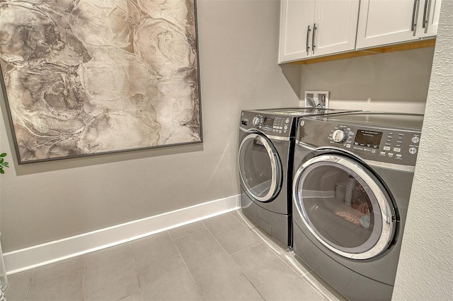 1919 Woodleaf Hammock Ct, Bradenton, FL 34211 - laundry area featuring washer and clothes dryer, cabinet space, baseboards, and tile patterned flooring