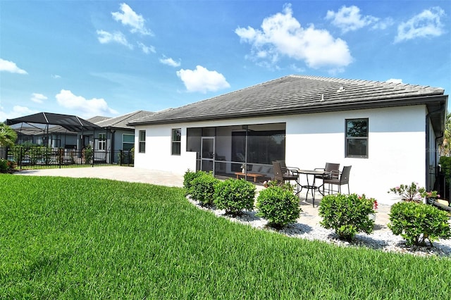 1919 Woodleaf Hammock Ct, Bradenton, FL 34211 - back of property with stucco siding, a patio, and a tiled roof