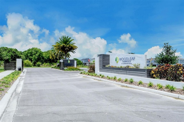 1919 Woodleaf Hammock Ct, Bradenton, FL 34211 - view of asphalt street with curbs and a gated entry
