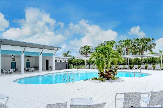 1919 Woodleaf Hammock Ct, Bradenton, FL 34211 - community pool with ceiling fan, a patio area, and outdoor dining space