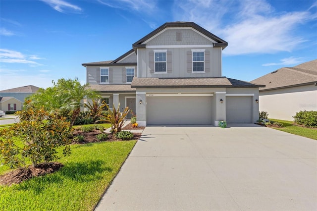 2332 Mizner Bay Ave, Bradenton, FL 34208 - craftsman house with an attached garage, driveway, stucco siding, roof with shingles, and a front yard