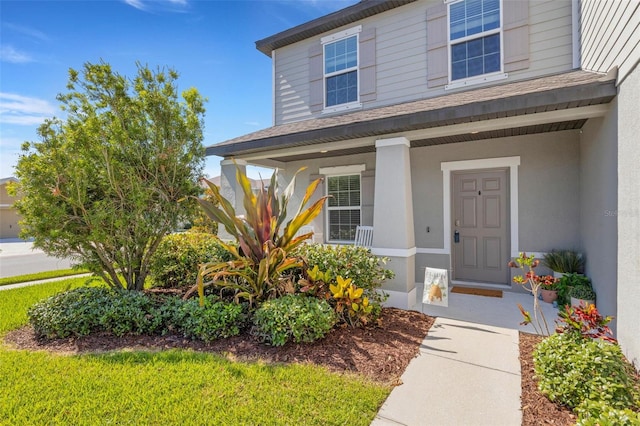 2332 Mizner Bay Ave, Bradenton, FL 34208 - entrance to property with a porch, stucco siding, and a shingled roof