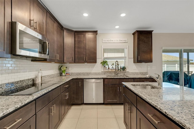 2332 Mizner Bay Ave, Bradenton, FL 34208 - kitchen with stainless steel appliances, ornamental molding, decorative backsplash, light stone countertops, and healthy amount of natural light