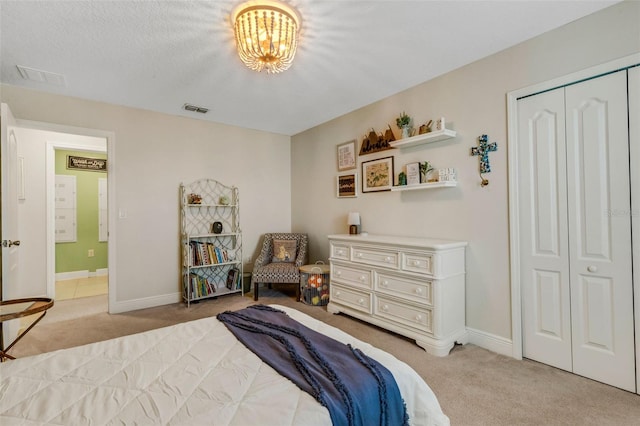 2332 Mizner Bay Ave, Bradenton, FL 34208 - bedroom featuring light carpet, a closet, a chandelier, and connected bathroom