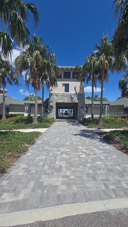 2332 Mizner Bay Ave, Bradenton, FL 34208 - view of front of property with decorative driveway, stone siding, and a carport