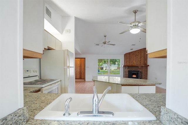 5639 Blount Ave, Sarasota, FL 34231 - kitchen featuring white appliances, lofted ceiling, ceiling fan, a brick fireplace, and a sink