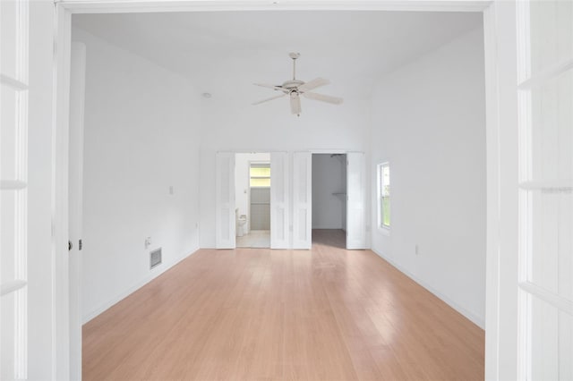 5639 Blount Ave, Sarasota, FL 34231 - unfurnished room featuring light wood-style floors, ceiling fan, baseboards, and vaulted ceiling