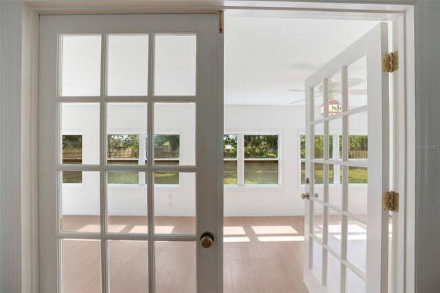 5639 Blount Ave, Sarasota, FL 34231 - doorway to outside featuring french doors, wood finished floors, and baseboards