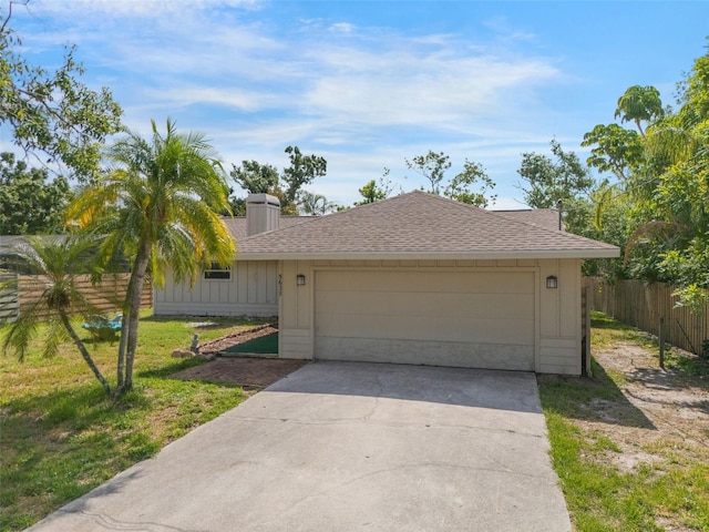 5639 Blount Ave, Sarasota, FL 34231 - ranch-style house with a shingled roof, a chimney, and a garage