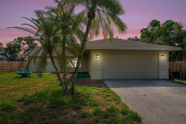 5639 Blount Ave, Sarasota, FL 34231 - view of front facade with driveway, a garage, and roof with shingles