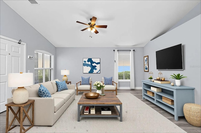 3429 97th Ln E, Palmetto, FL 34221 - living room with healthy amount of natural light, ceiling fan, wood finished floors, vaulted ceiling, and baseboards