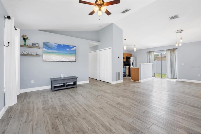3429 97th Ln E, Palmetto, FL 34221 - unfurnished living room with a ceiling fan, lofted ceiling, light wood-type flooring, and baseboards