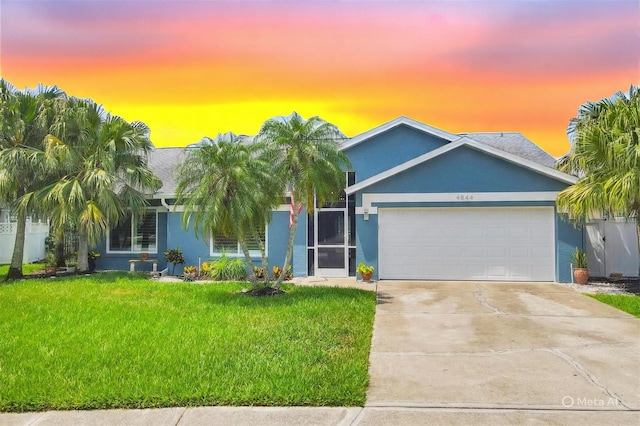 4844 14th Ave E, Bradenton, FL 34208 - single story home with a lawn, a garage, stucco siding, and driveway