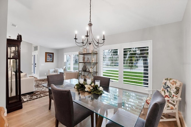 4844 14th Ave E, Bradenton, FL 34208 - dining room featuring a chandelier and light wood finished floors