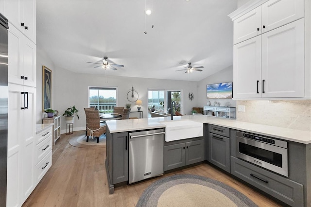 4844 14th Ave E, Bradenton, FL 34208 - kitchen featuring stainless steel dishwasher, gray cabinets, ceiling fan, a peninsula, and light countertops