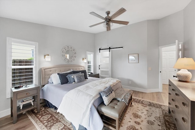 4844 14th Ave E, Bradenton, FL 34208 - bedroom with light wood-style floors, multiple windows, and a barn door