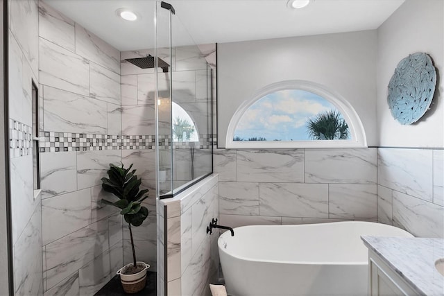 4844 14th Ave E, Bradenton, FL 34208 - bathroom featuring a freestanding bath, a stall shower, vanity, tile walls, and recessed lighting