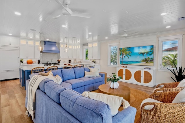 135 Avenida Veneccia, Sarasota, FL 34242 - living room with ceiling fan, recessed lighting, light wood-type flooring, and crown molding