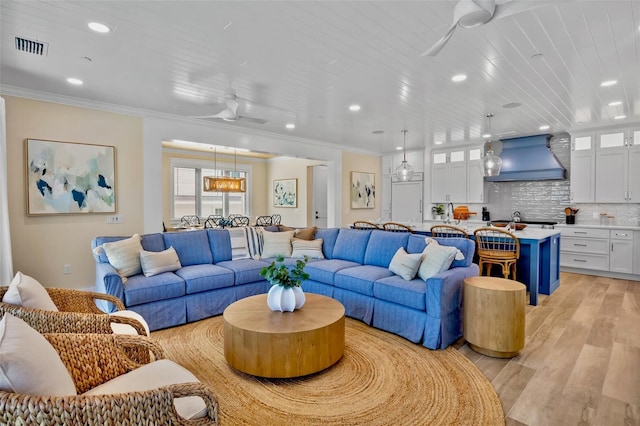 135 Avenida Veneccia, Sarasota, FL 34242 - living area featuring a ceiling fan, light wood-style floors, crown molding, and recessed lighting