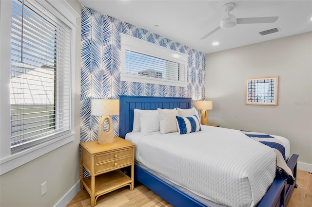 135 Avenida Veneccia, Sarasota, FL 34242 - bedroom featuring an accent wall, wood finished floors, recessed lighting, and a ceiling fan