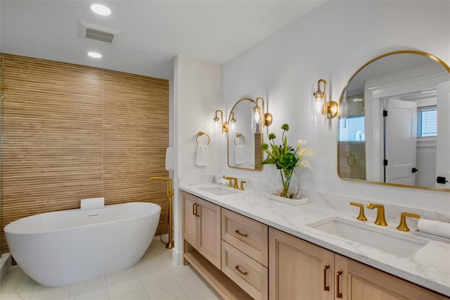 135 Avenida Veneccia, Sarasota, FL 34242 - bathroom featuring double vanity, a soaking tub, marble look tile flooring, and recessed lighting