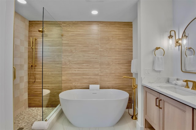 135 Avenida Veneccia, Sarasota, FL 34242 - full bathroom with tile walls, a shower stall, vanity, a freestanding tub, and tile patterned flooring