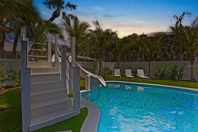135 Avenida Veneccia, Sarasota, FL 34242 - view of swimming pool featuring a water slide, a fenced backyard, and stairway