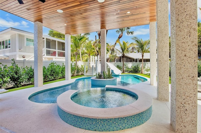 135 Avenida Veneccia, Sarasota, FL 34242 - view of pool with a water slide, a pool with connected hot tub, stairway, and a sunroom