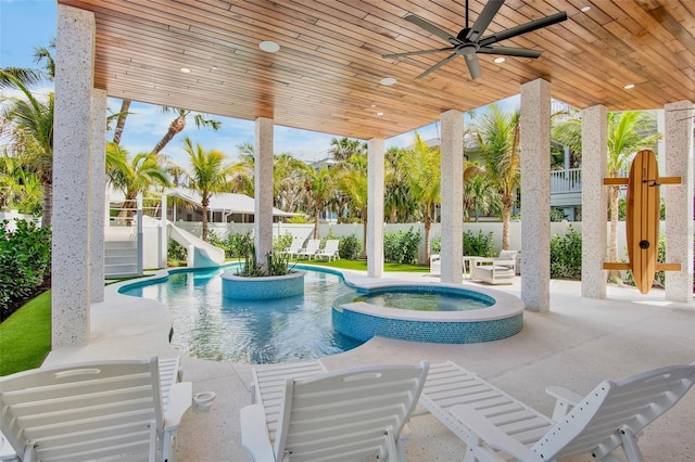 135 Avenida Veneccia, Sarasota, FL 34242 - view of swimming pool with a ceiling fan, a patio area, a fenced backyard, a pool with connected hot tub, and a water slide