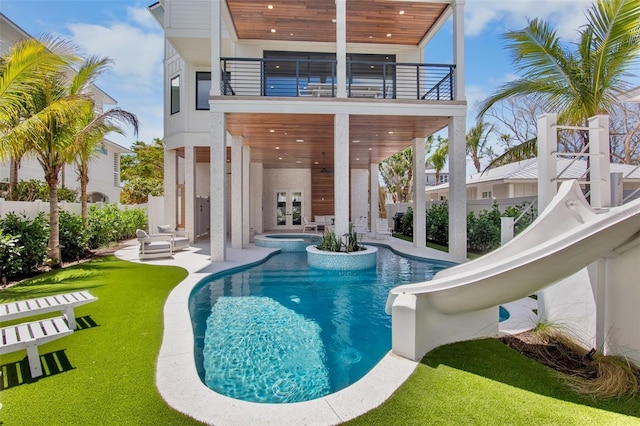 135 Avenida Veneccia, Sarasota, FL 34242 - rear view of house with a balcony, a patio area, french doors, and a pool with connected hot tub