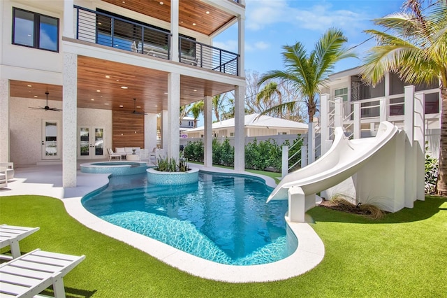 135 Avenida Veneccia, Sarasota, FL 34242 - view of swimming pool featuring french doors, a water slide, a patio, ceiling fan, and a pool with connected hot tub