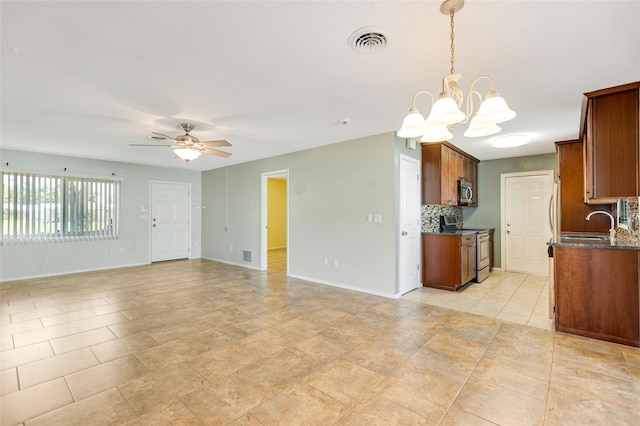 4375 Tortoise Rd, Venice, FL 34293 - kitchen featuring stainless steel appliances, a chandelier, decorative backsplash, a ceiling fan, and open floor plan