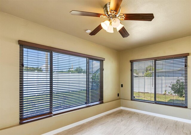 4375 Tortoise Rd, Venice, FL 34293 - spare room featuring healthy amount of natural light, marble look tile flooring, baseboards, and a ceiling fan