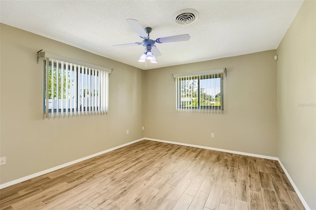 4375 Tortoise Rd, Venice, FL 34293 - unfurnished room with wood finished floors, a ceiling fan, baseboards, and a textured ceiling