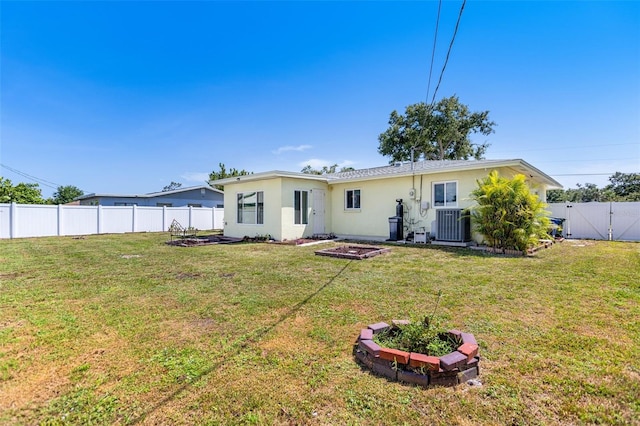 4375 Tortoise Rd, Venice, FL 34293 - back of house with stucco siding, cooling unit, and a gate
