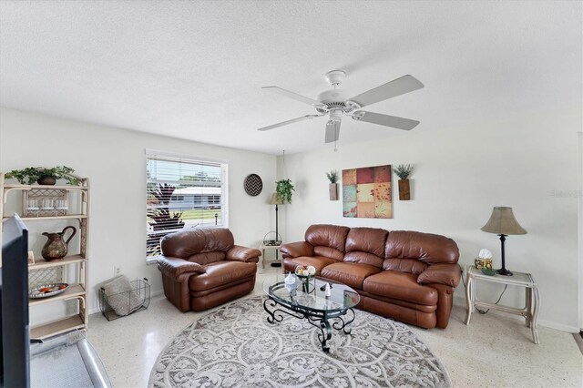 4535 Maceachen Blvd, Sarasota, FL 34233 - living room featuring speckled floor, baseboards, ceiling fan, and a textured ceiling