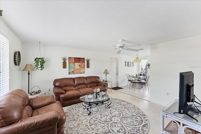 4535 Maceachen Blvd, Sarasota, FL 34233 - living room with dark aggregate flooring, a ceiling fan, and a textured ceiling