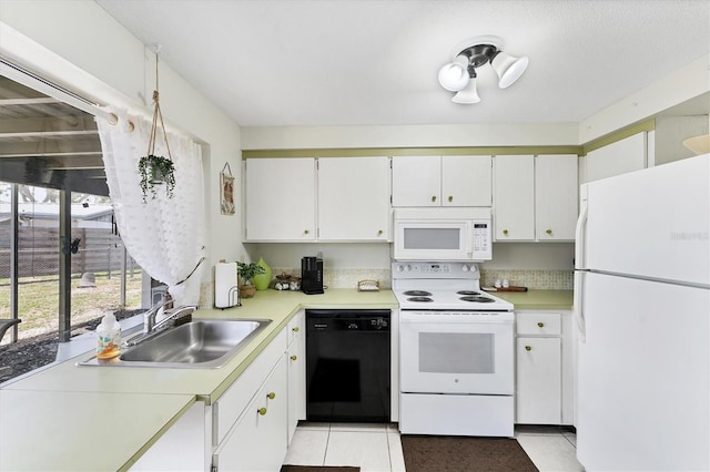 4535 Maceachen Blvd, Sarasota, FL 34233 - kitchen featuring white appliances, a sink, light countertops, and light tile patterned flooring