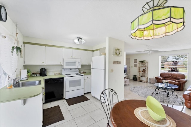 4535 Maceachen Blvd, Sarasota, FL 34233 - kitchen with white appliances, a sink, light countertops, open floor plan, and light tile patterned floors