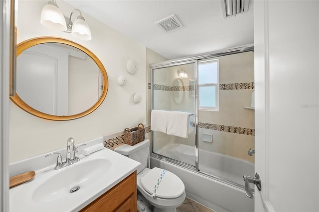 308 Canal Rd, Sarasota, FL 34242 - bathroom with vanity, toilet, and bath / shower combo with glass door