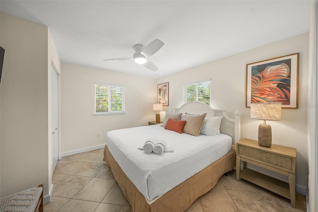 308 Canal Rd, Sarasota, FL 34242 - bedroom with light tile patterned floors, a ceiling fan, and baseboards