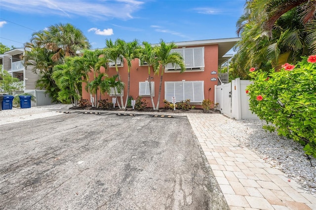 308 Canal Rd, Sarasota, FL 34242 - view of front of house with uncovered parking, stucco siding, and a gate