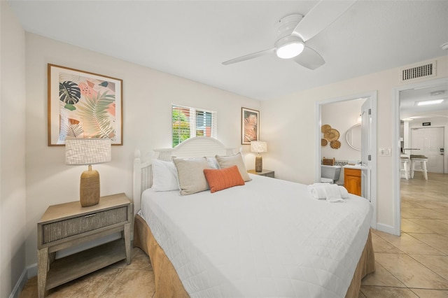 308 Canal Rd, Sarasota, FL 34242 - bedroom with light tile patterned floors, a ceiling fan, and baseboards