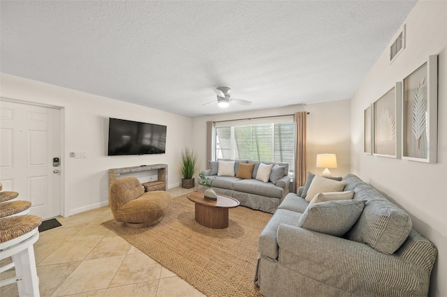 308 Canal Rd, Sarasota, FL 34242 - living room featuring a ceiling fan, a textured ceiling, and light tile patterned flooring