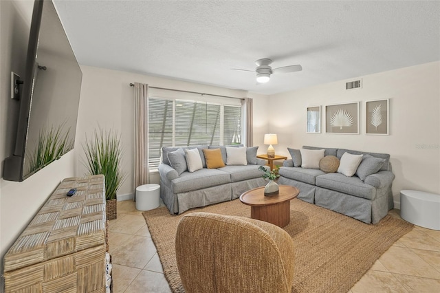308 Canal Rd, Sarasota, FL 34242 - living area featuring light tile patterned floors, a ceiling fan, and a textured ceiling