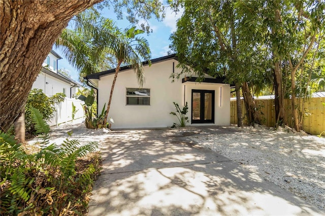 2410 Floyd St, Sarasota, FL 34239 - view of front of house with french doors, stucco siding, and a patio area