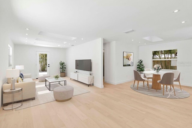 2410 Floyd St, Sarasota, FL 34239 - living area featuring light wood-style flooring, recessed lighting, and a skylight